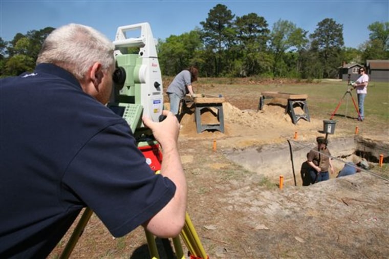 In an undated photo provided by Georgia Southern University, graduate student Kevin Chapman surveys the site at Camp Lawton while students dig in a trench in search of artifacts. 